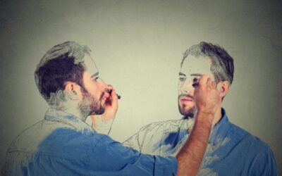 Man sketching his own portrait on a grey background