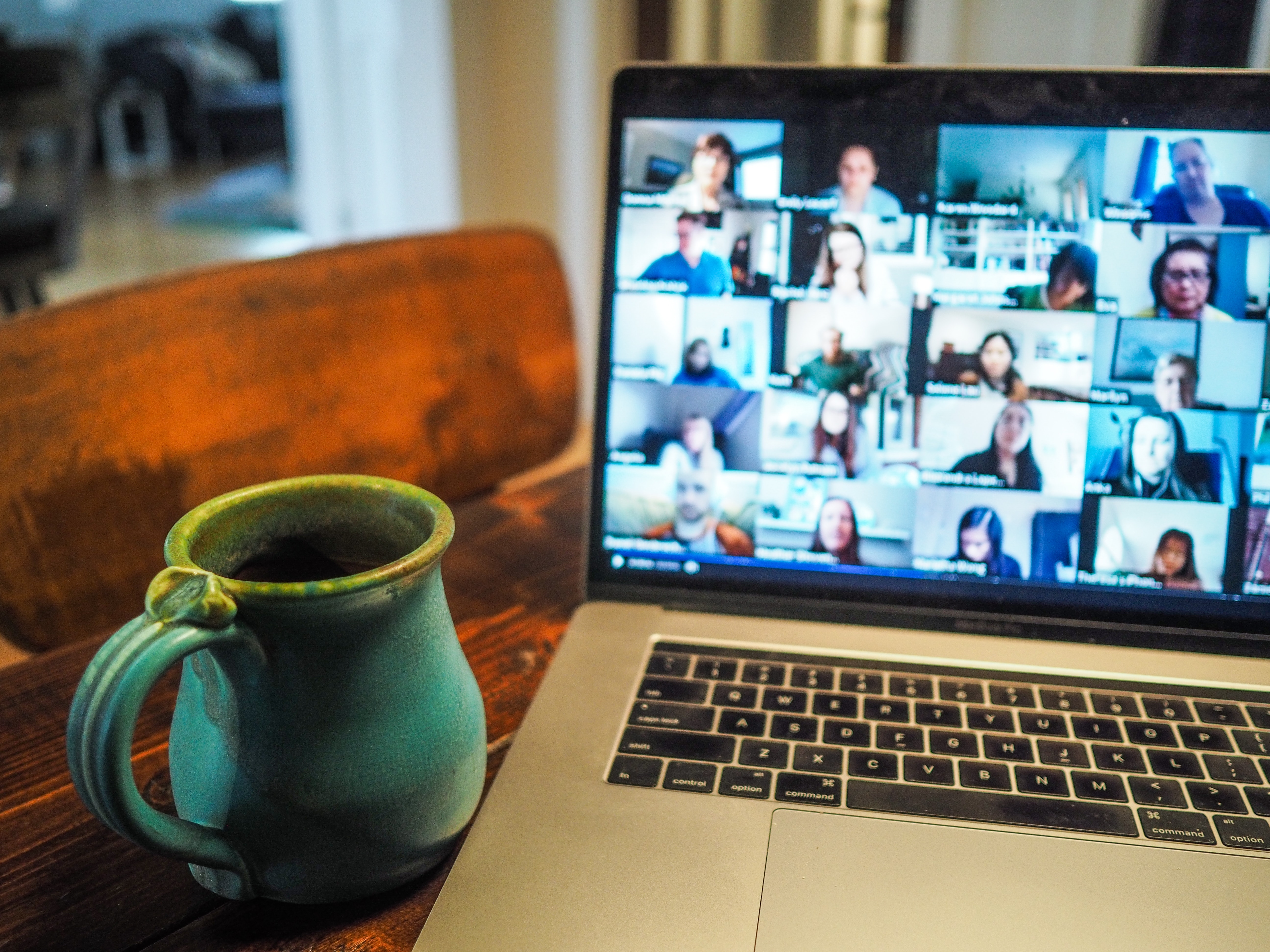 Laptop showing a video call with a coffee mug in the foreground