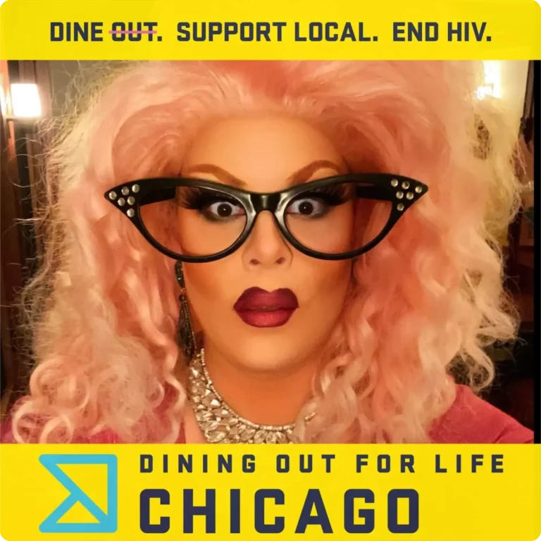 Drag performer in a pink wig at a Dining Out for Life Chicago event photo booth