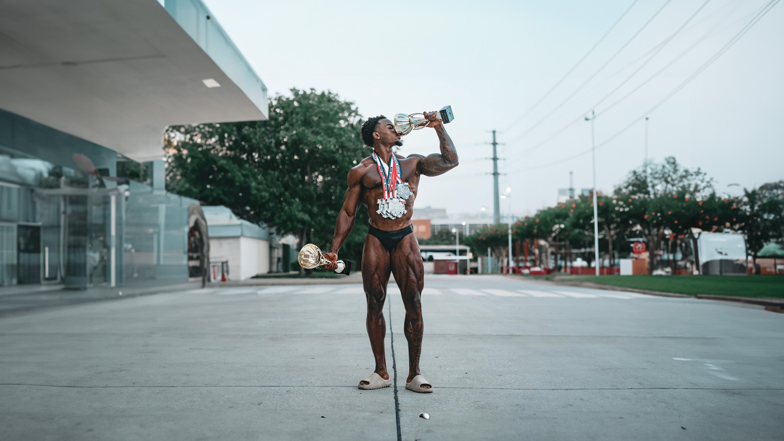 Champion bodybuilder with competition trophies