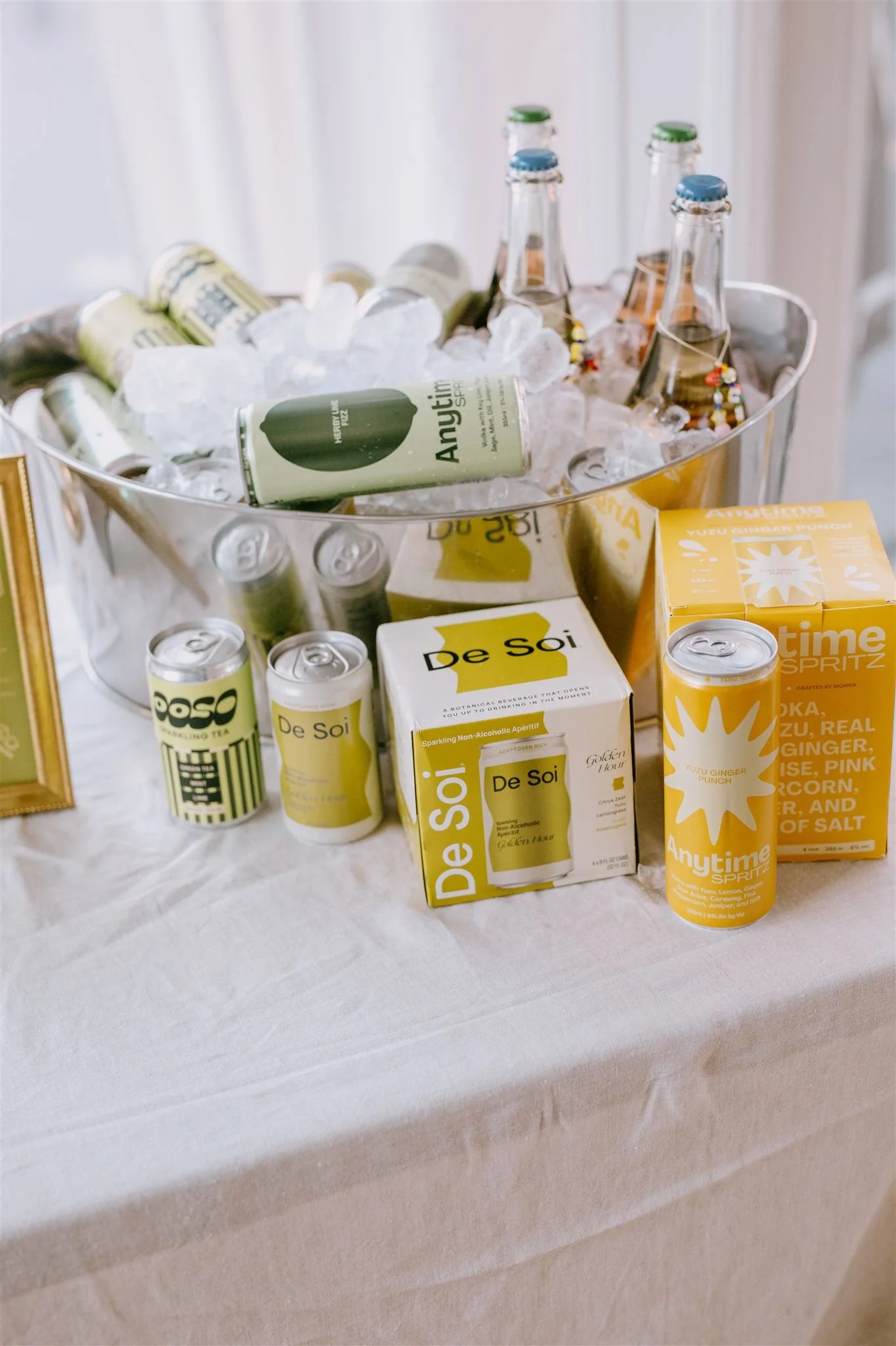 Bar station with De Soi and Anytime Spritz cans in an ice bucket at a Bread & Butter Law event