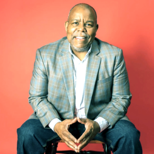 Marvin Worthy, smiling in a plaid blazer