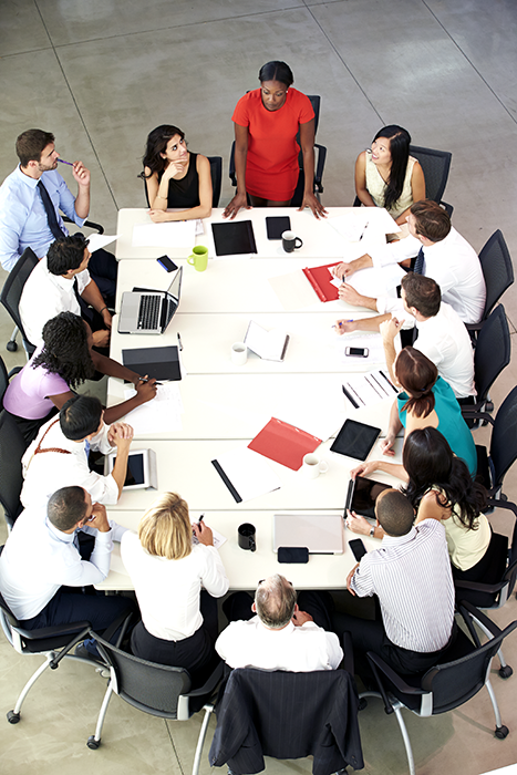 Overhead shot of diverse business professionals gathered around a conference table