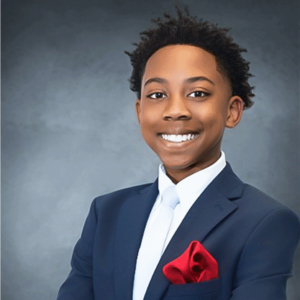 Anthony Campbell, smiling in a navy suit with a red pocket square