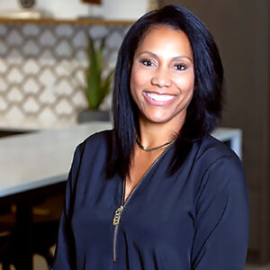 Tonya Webb Wallace, smiling in a navy blouse