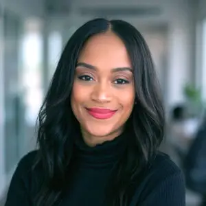 Kimberly Campbell, smiling in a black turtleneck in an office setting