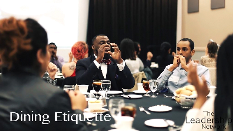Formal dining etiquette training session at round banquet tables