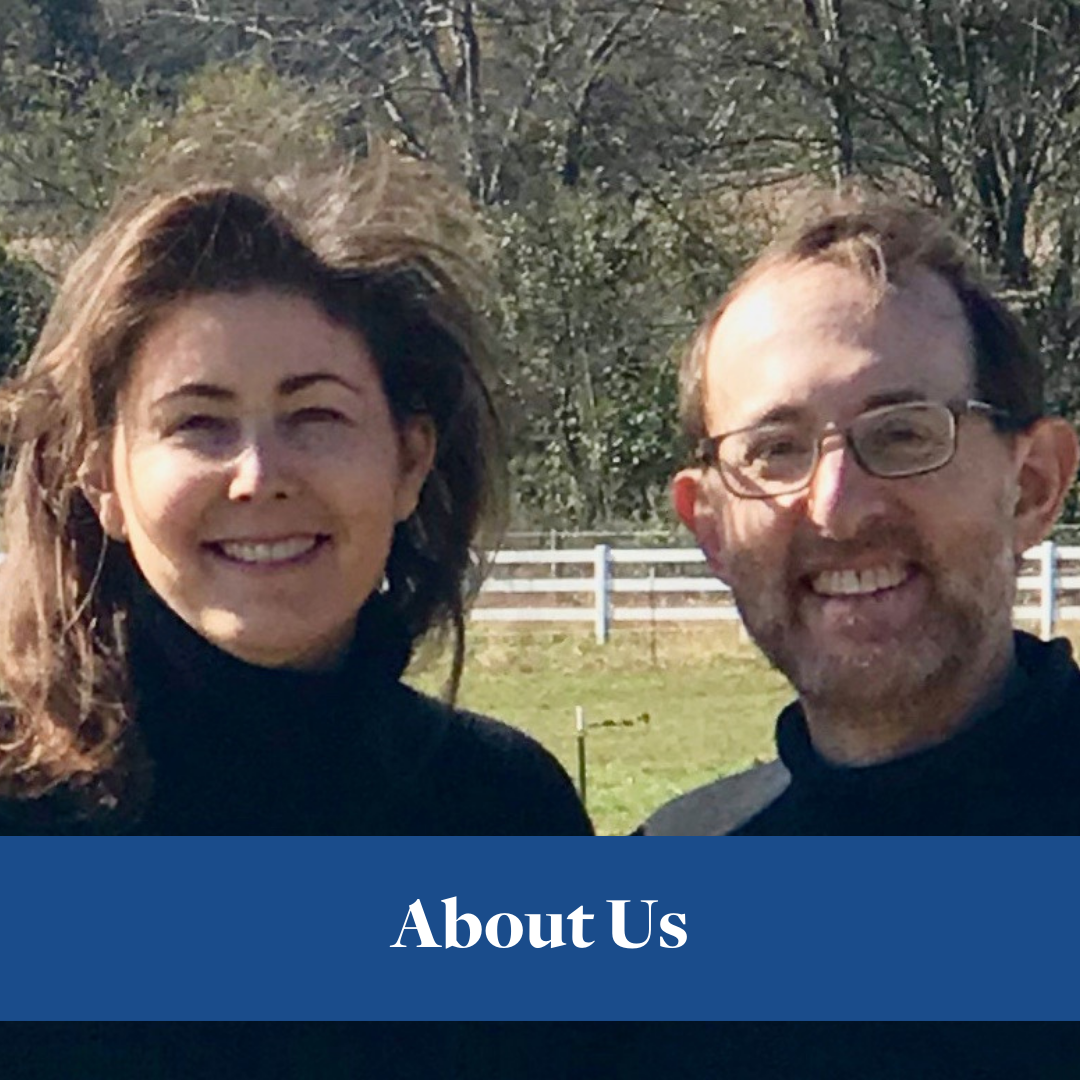 Audrey and Henry Levin smiling together outdoors beside a white fence