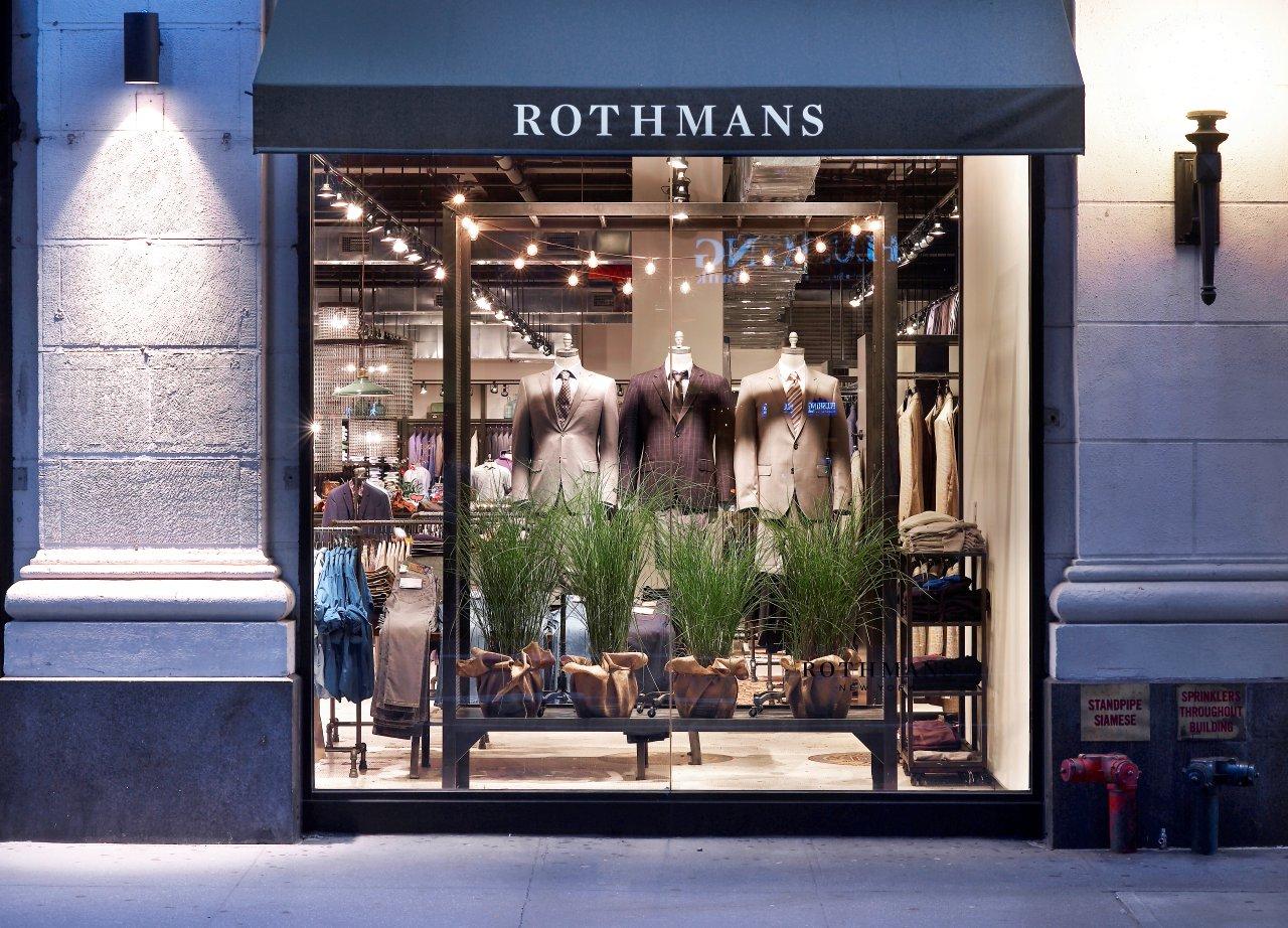 Rothmans menswear shopfront at dusk with three suit mannequins lit in the window
