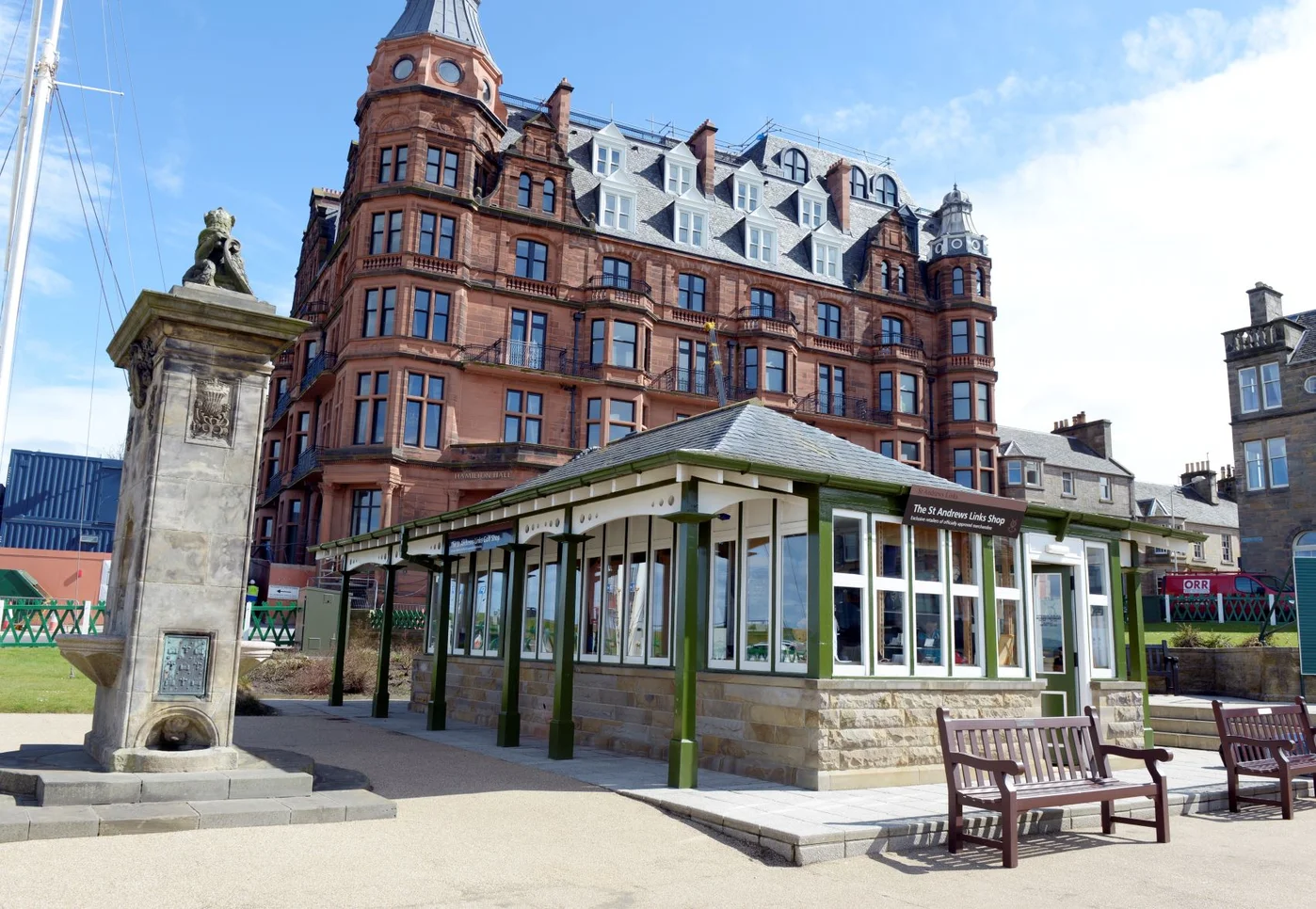 Grand red-brick Victorian hotel with the St Andrews Links Shop pavilion in the foreground