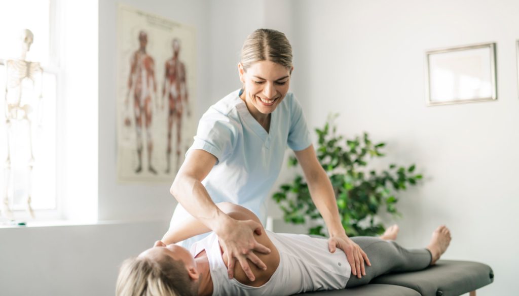 Therapist performing manual therapy on a patient on a treatment table