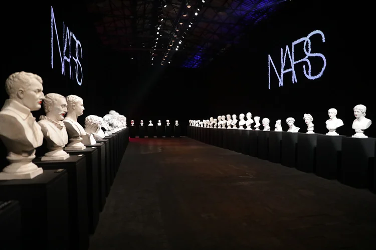 NARS 25th Anniversary hall with white busts and a projected logo