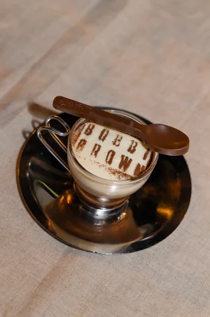 Bobbi Brown branded latte art in a glass cup