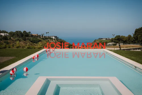 Josie Maran Malibu pool with branded red letters
