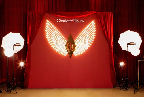 Charlotte Tilbury neon angel wings branded backdrop