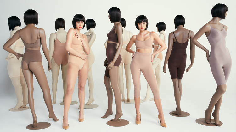 SKIMS anniversary shoot with models among diverse-skin-tone mannequins