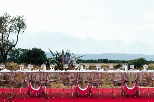 NARS Italy Glow Dinner table set on a red carpet in a field