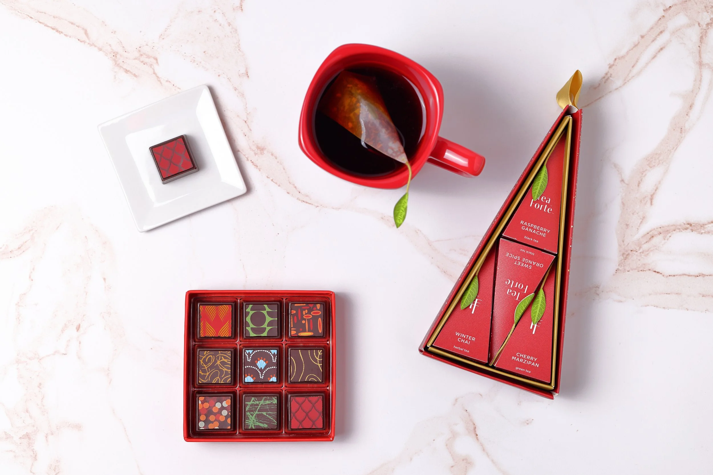 Delysia artisan chocolate box with tea in a flat-lay
