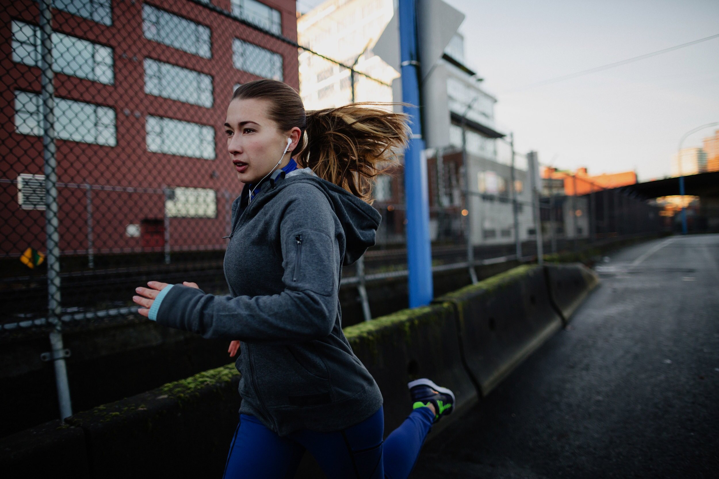 Runner training on an urban street at dawn