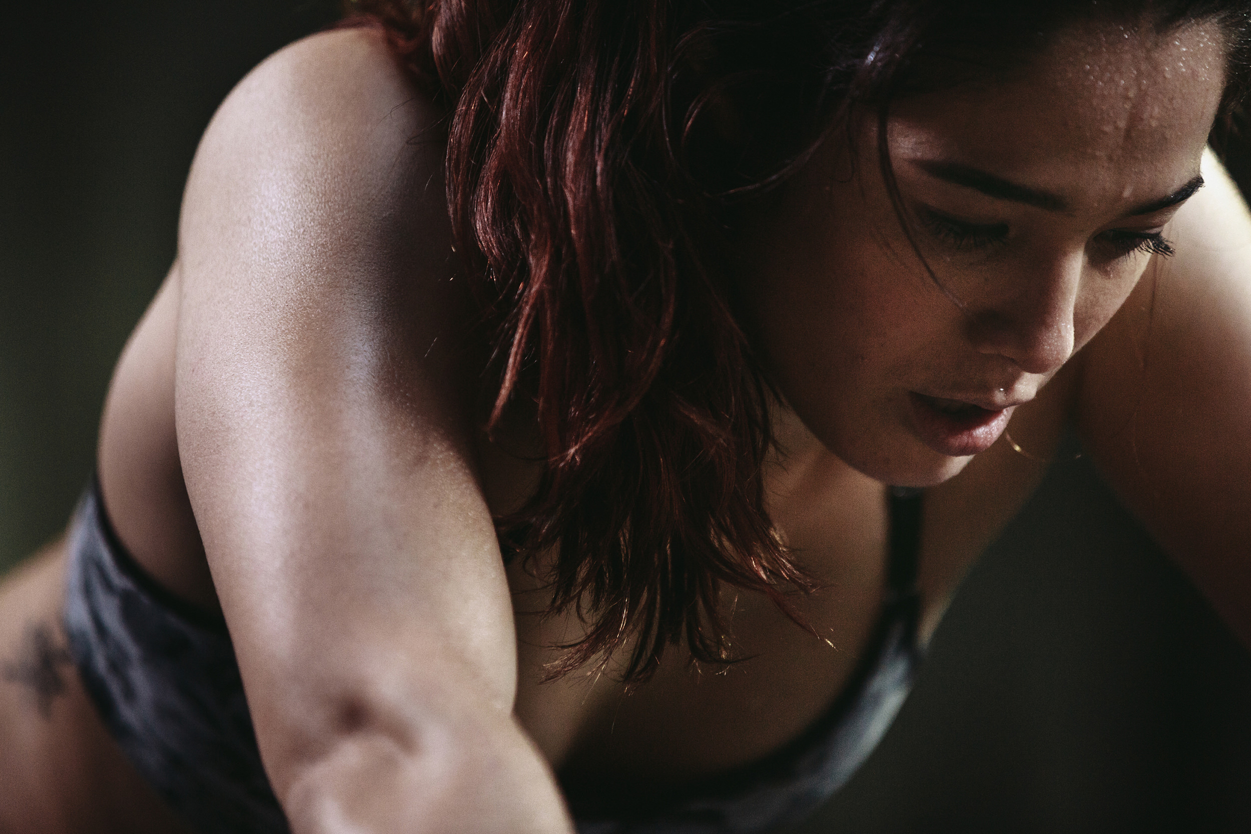 Sweating athlete leaning forward after intense effort