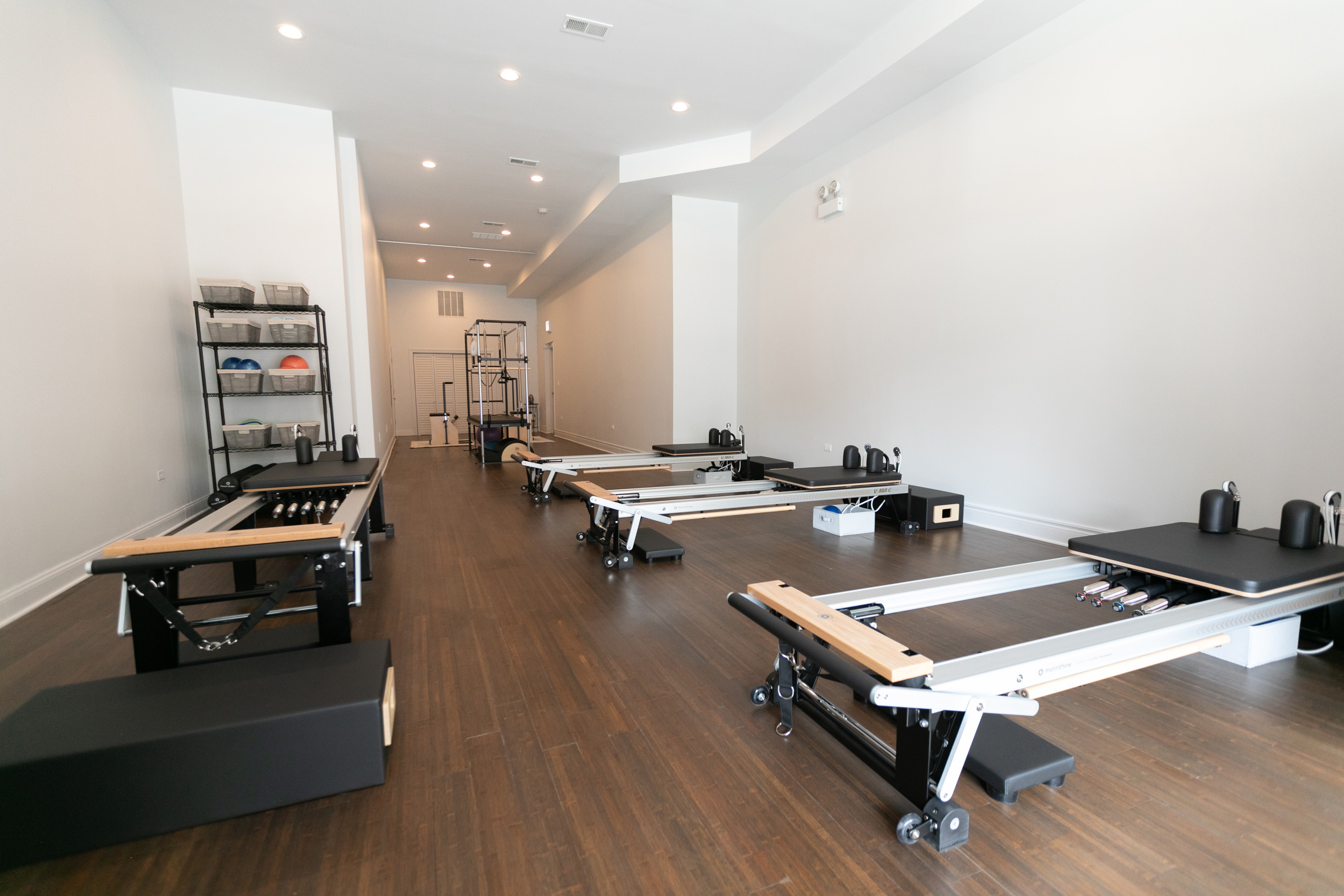 Empty studio interior with a row of reformer machines