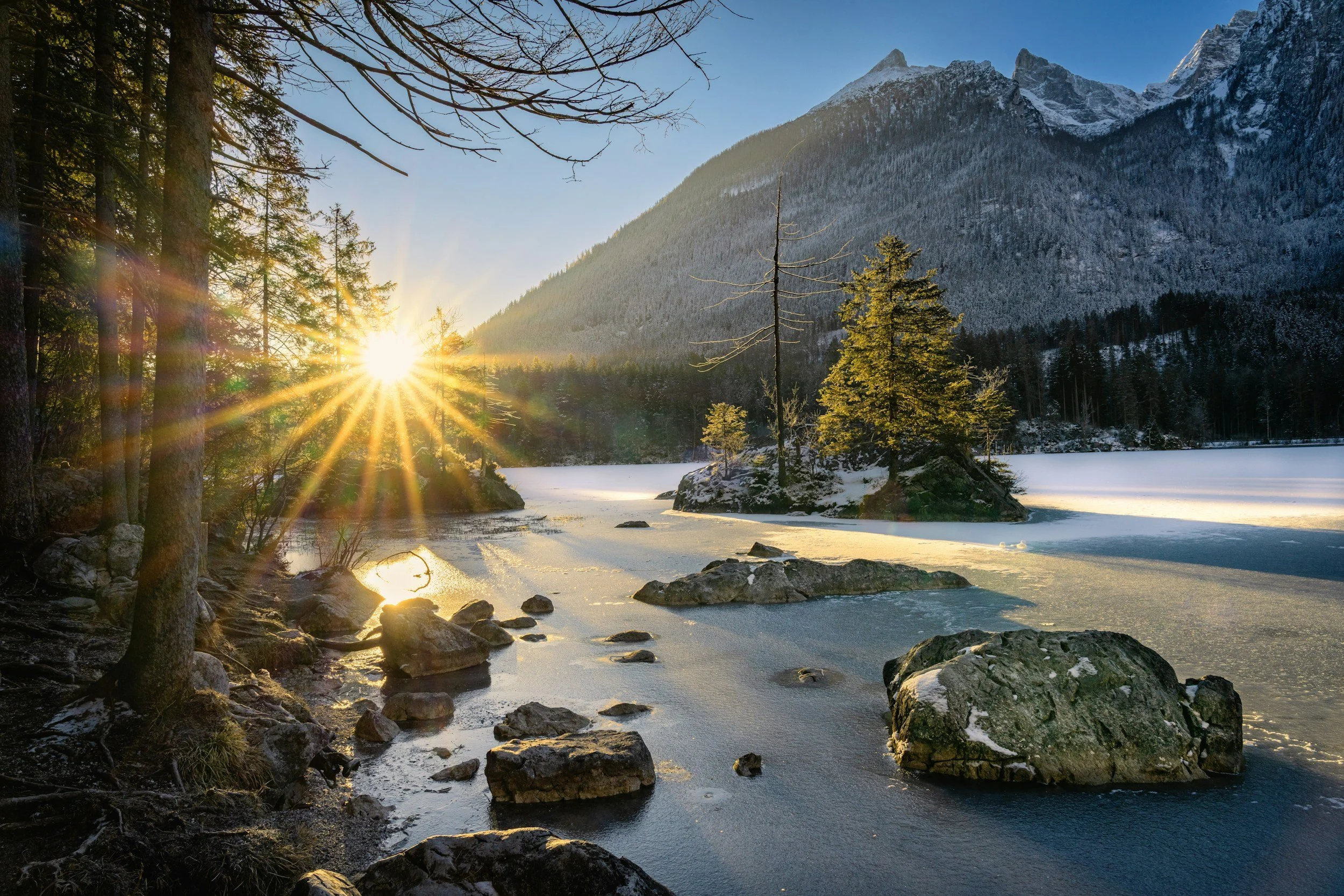 Sunrise over a frozen mountain lake
