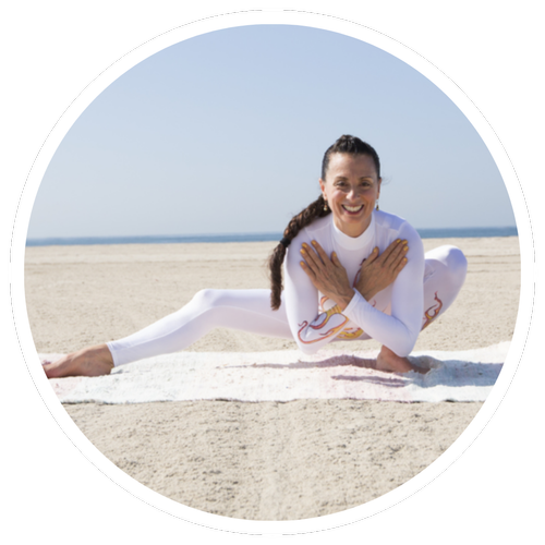 Pa'mela Carrara in a seated yoga pose on the beach