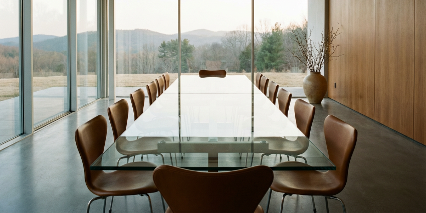Empty modern boardroom with a long glass conference table
