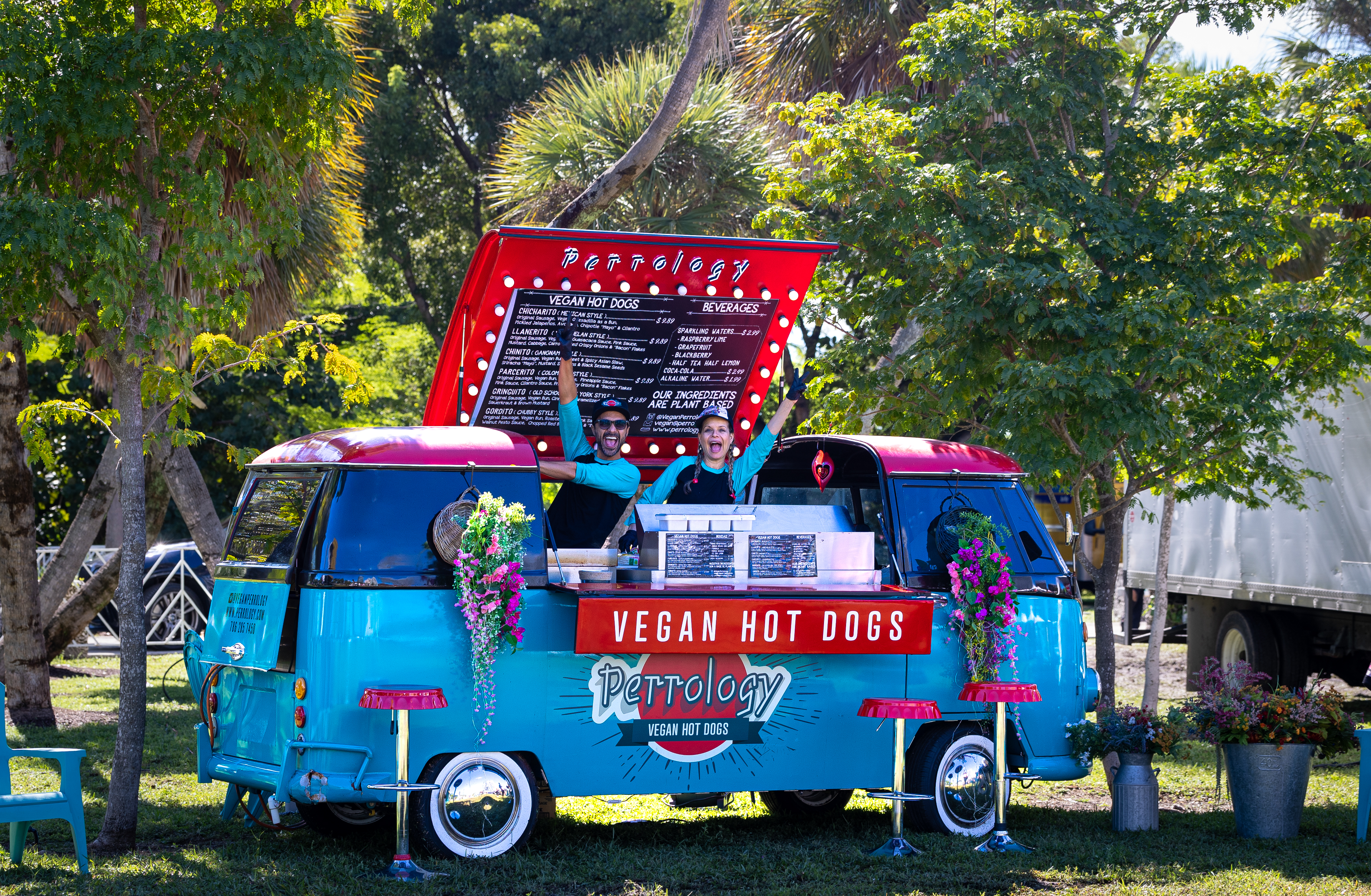 Vintage VW bus food truck, Perrology Vegan Hot Dogs, with vendors waving