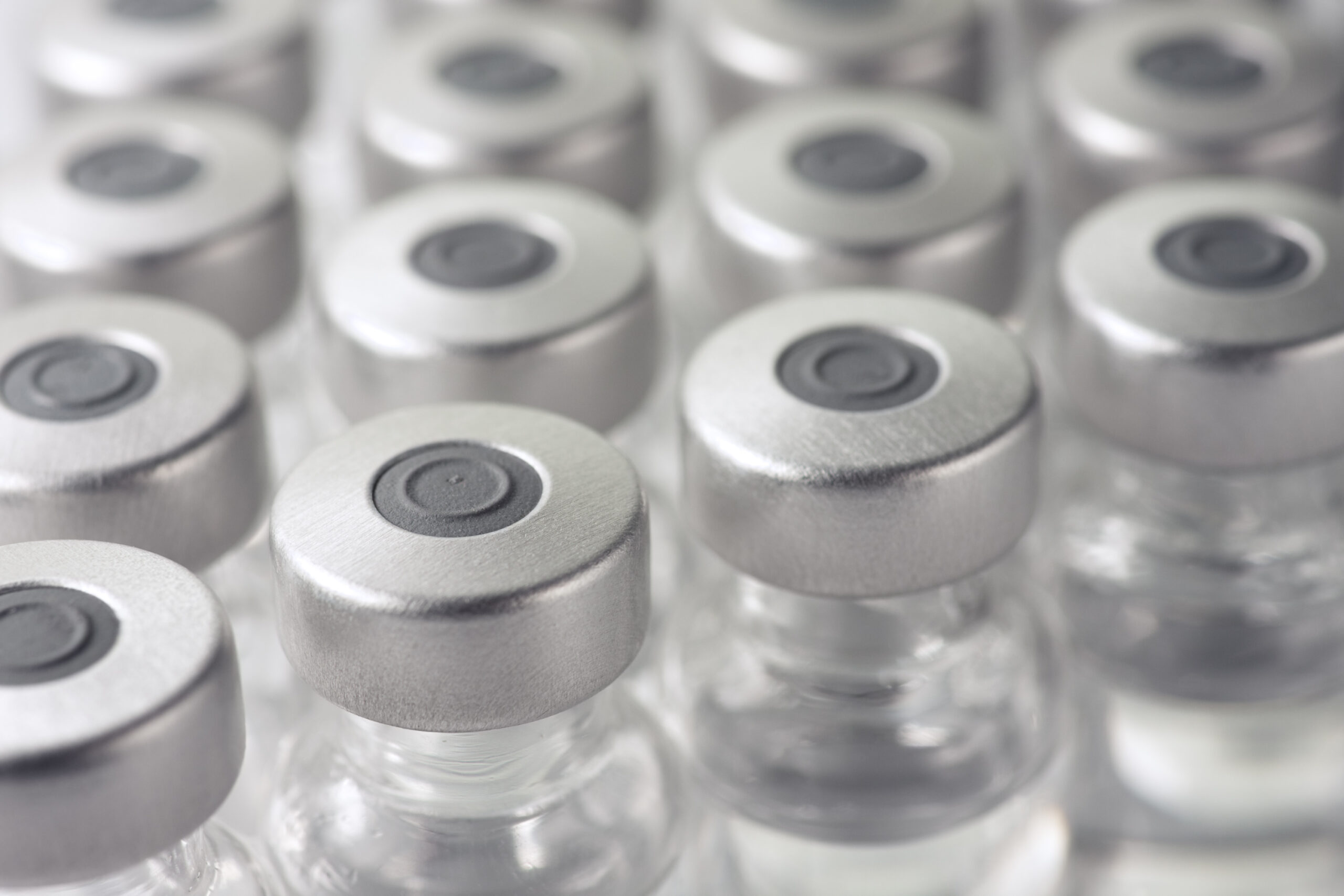 Close-up of medical vials arranged in rows