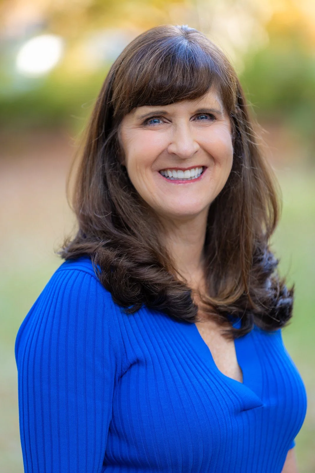 Dr. Holly Ward, founder of Shore Coaching, smiling outdoors