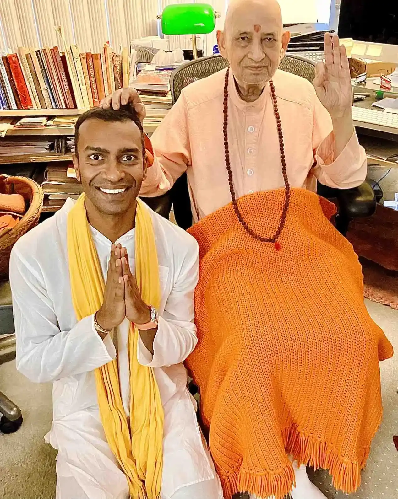 Sri Sudarshan kneeling to receive his guru's blessing