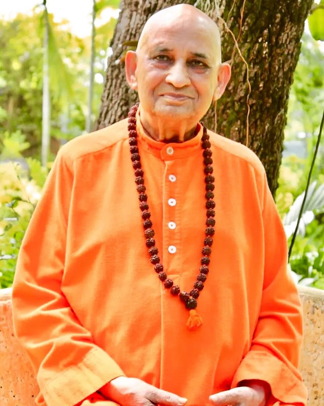 Swami Nikhilananda Saraswati seated outdoors