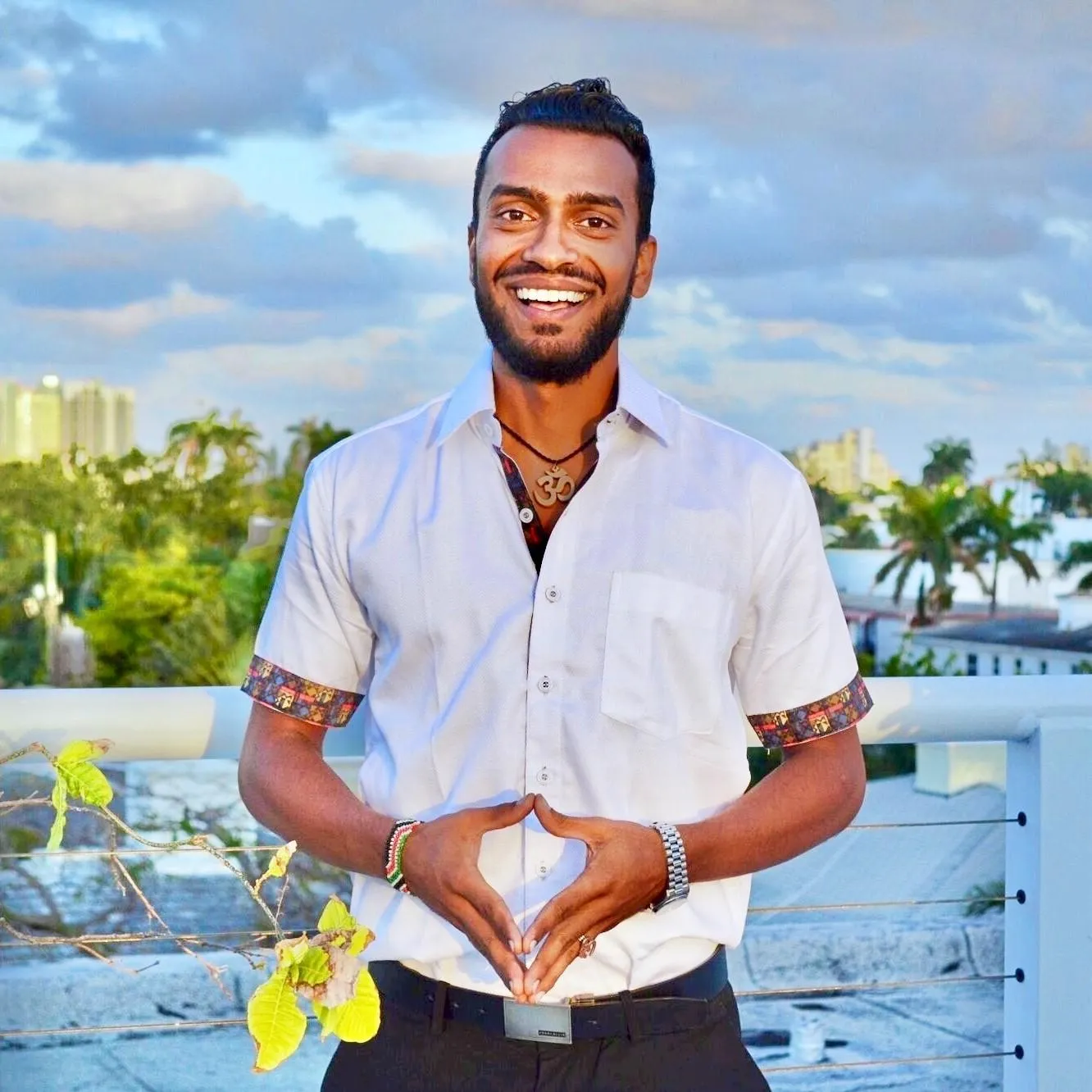 Sri Sudarshan in a white shirt with the Miami skyline behind