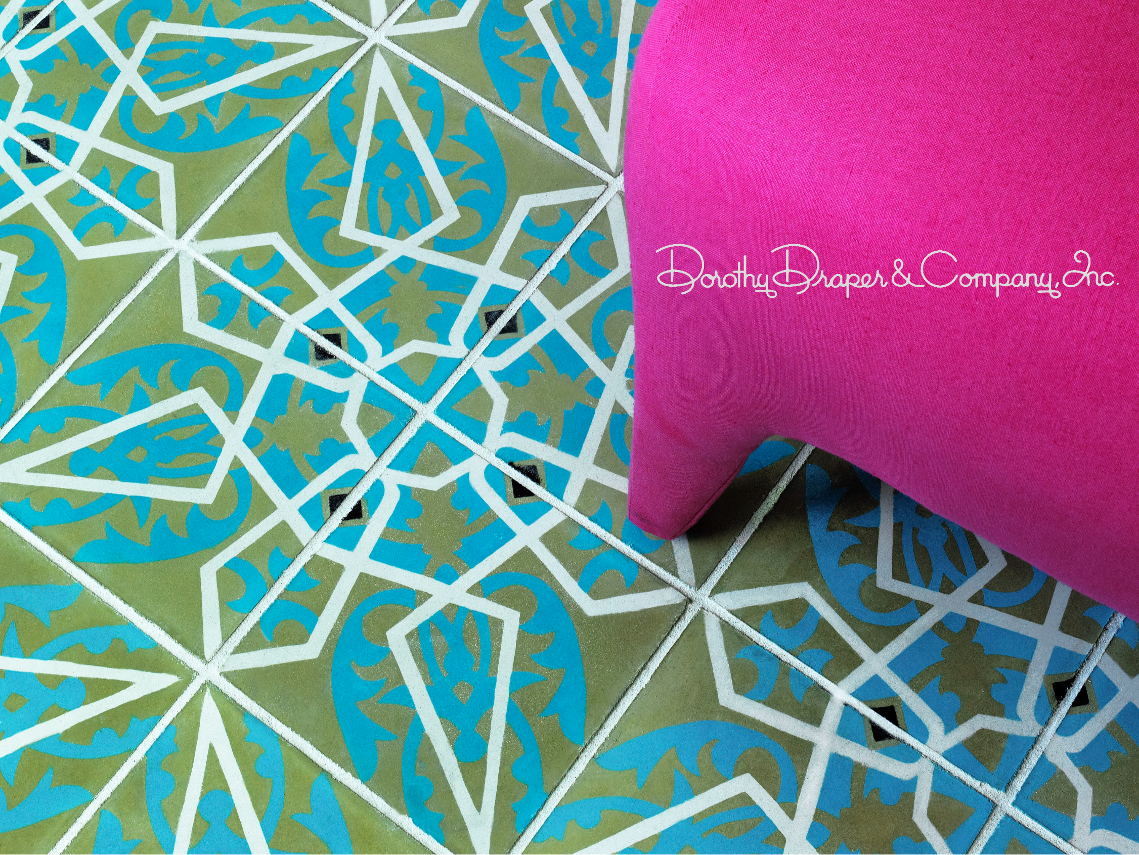 Decorative tile floor in teal, olive and white geometric pattern with a hot-pink pillow, watermarked Dorothy Draper & Company Inc.