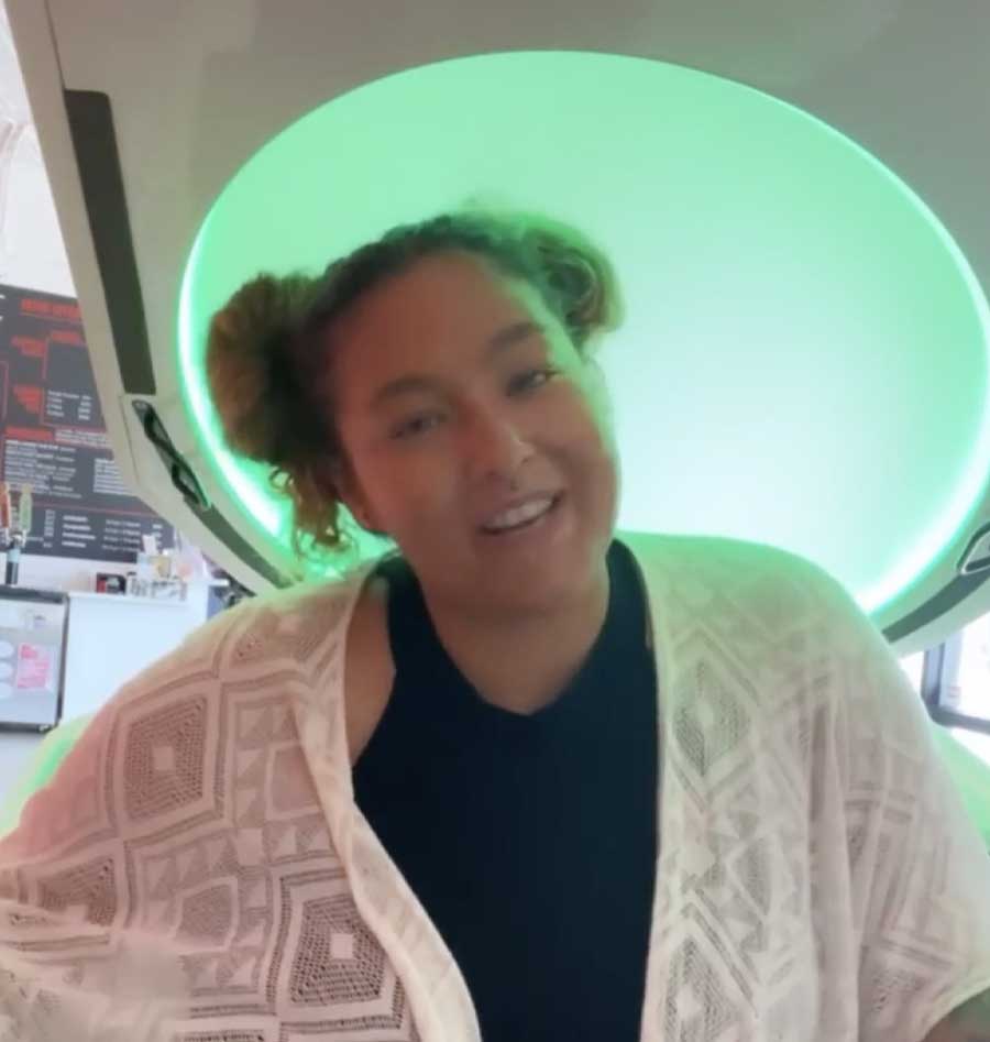 A woman in front of a green-lit Somadome