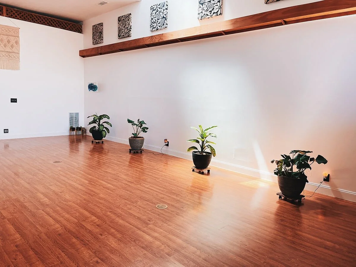 The Breathing Room studio in Alameda, a bright practice space with plants and hardwood floors