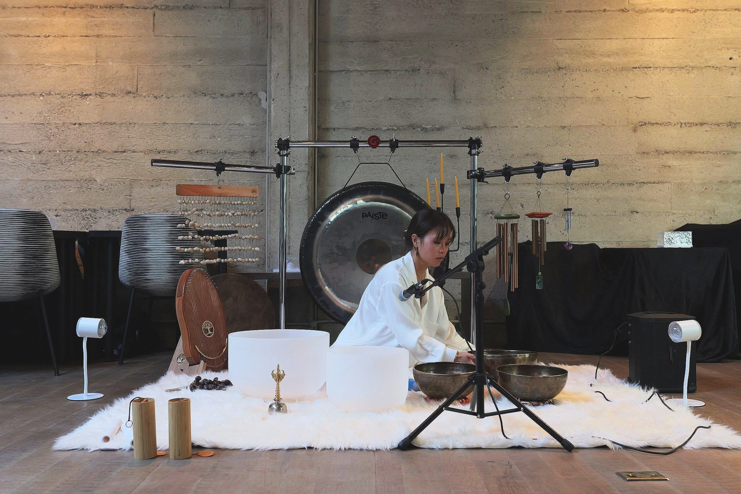 Erica Nguyễn's full sound bath setup of gongs, crystal bowls, singing bowls and wind chimes