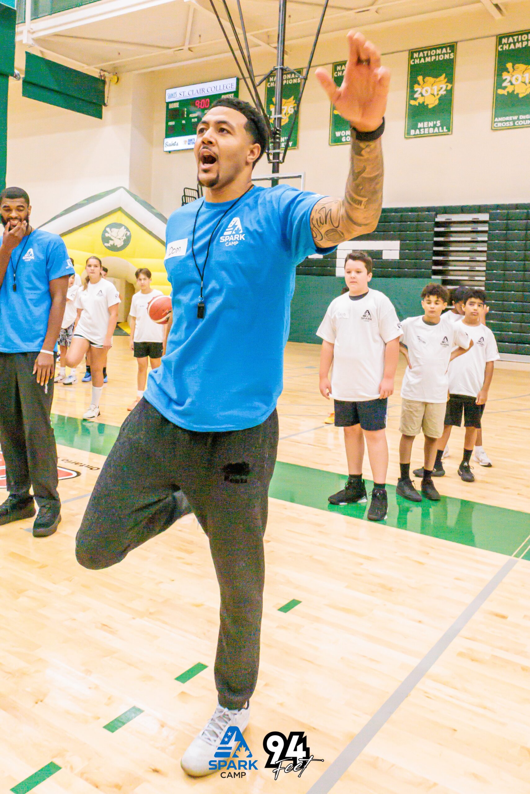 Spark Camp coach jumping and gesturing on the basketball court