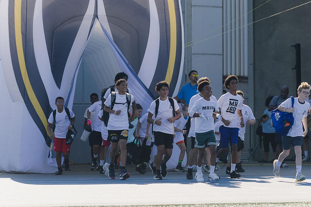 Campers running out of an inflatable tunnel entrance