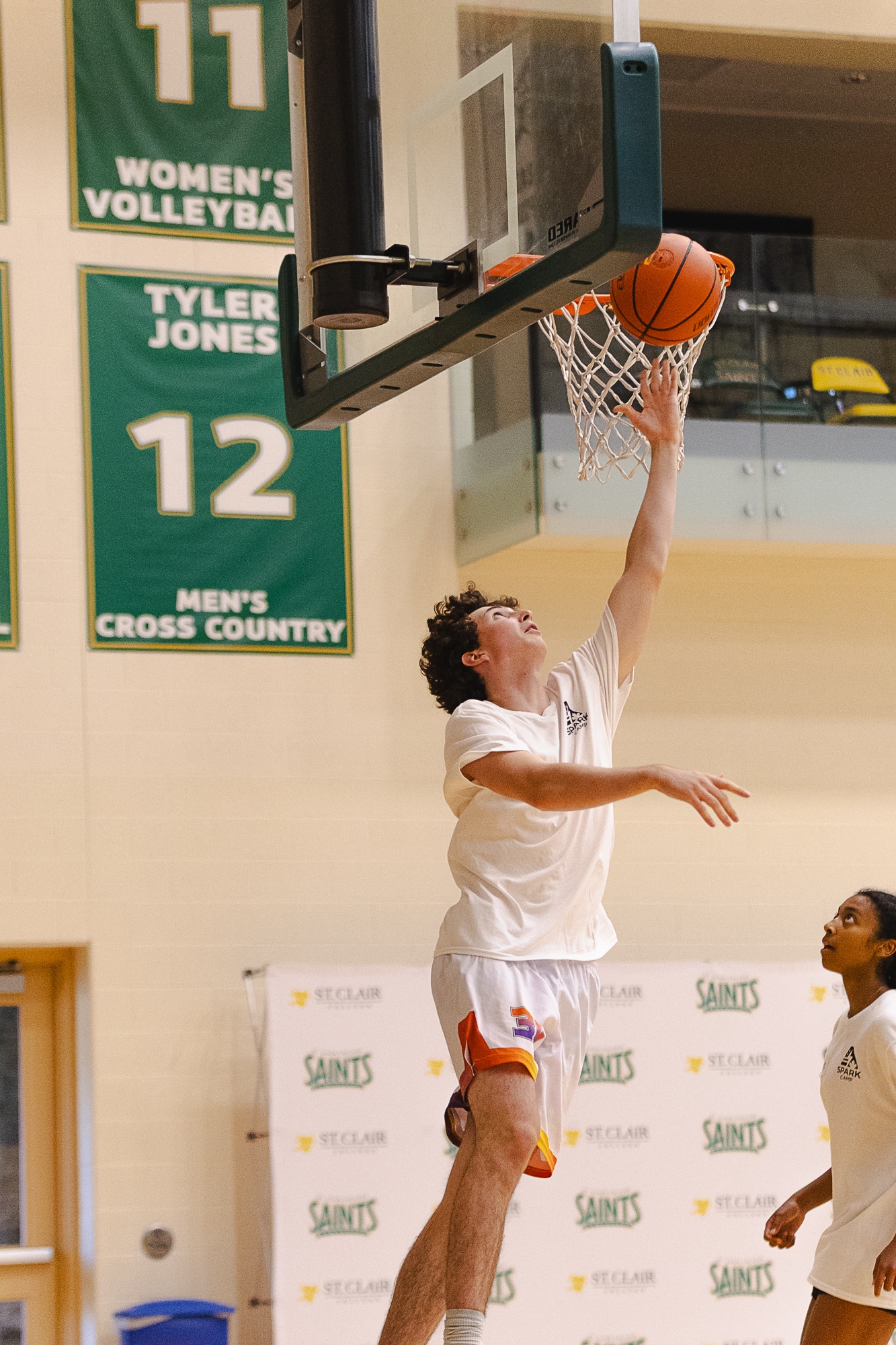 Camper jumping for a layup at the rim