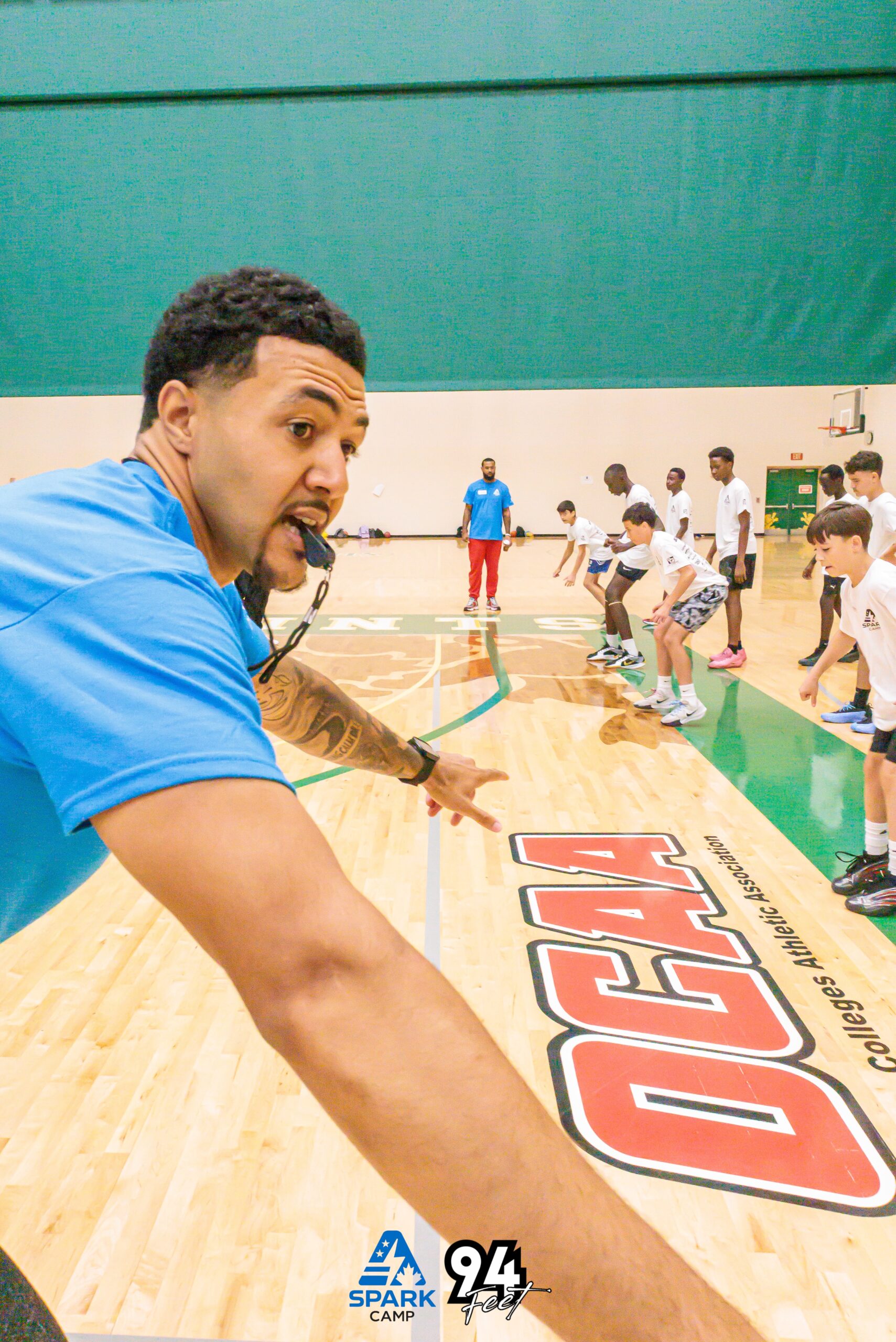 Coach instructing kids lined up on the court