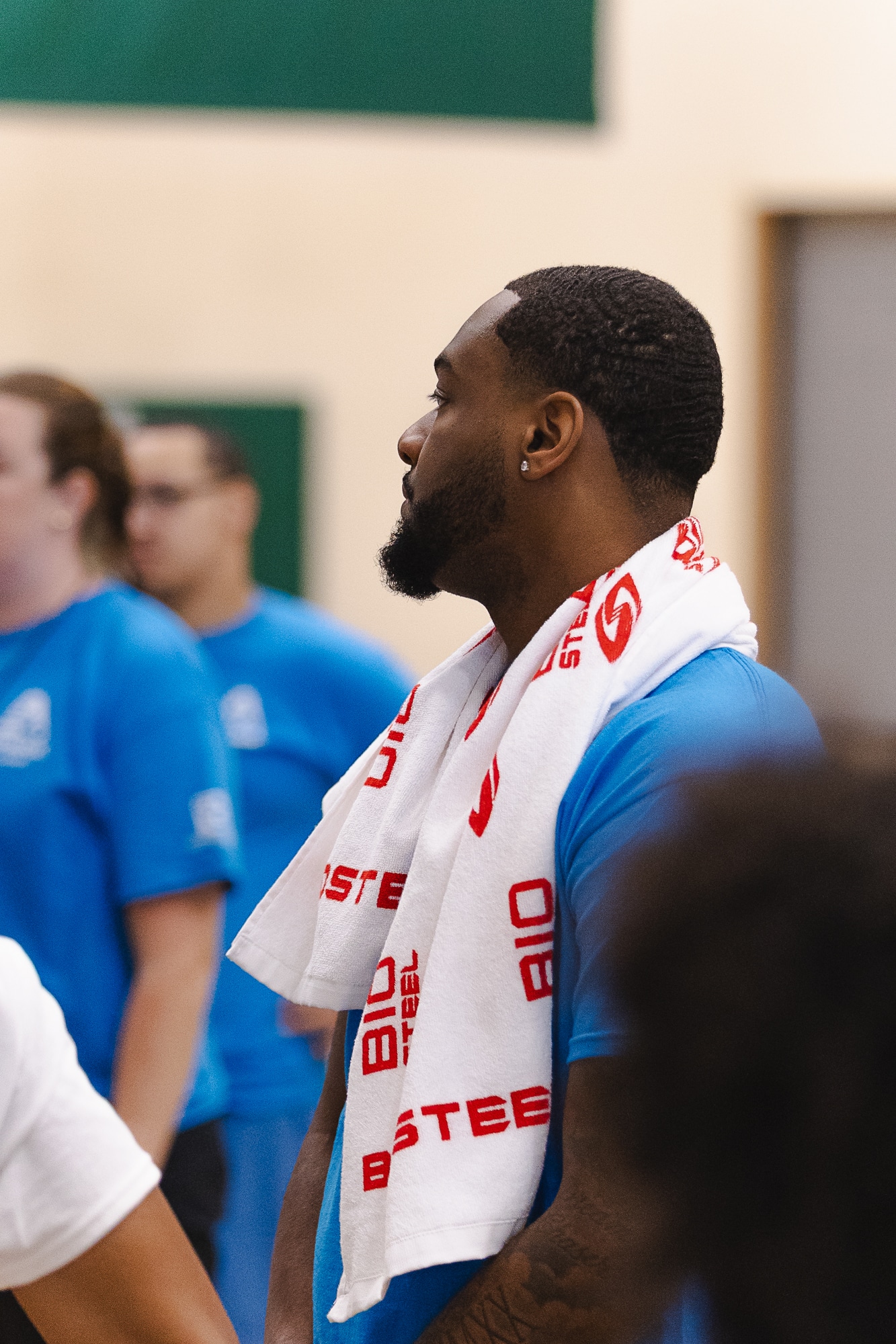 Coach with a BioSteel towel watching the action in the gym
