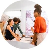 Women collaborating around a table with papers