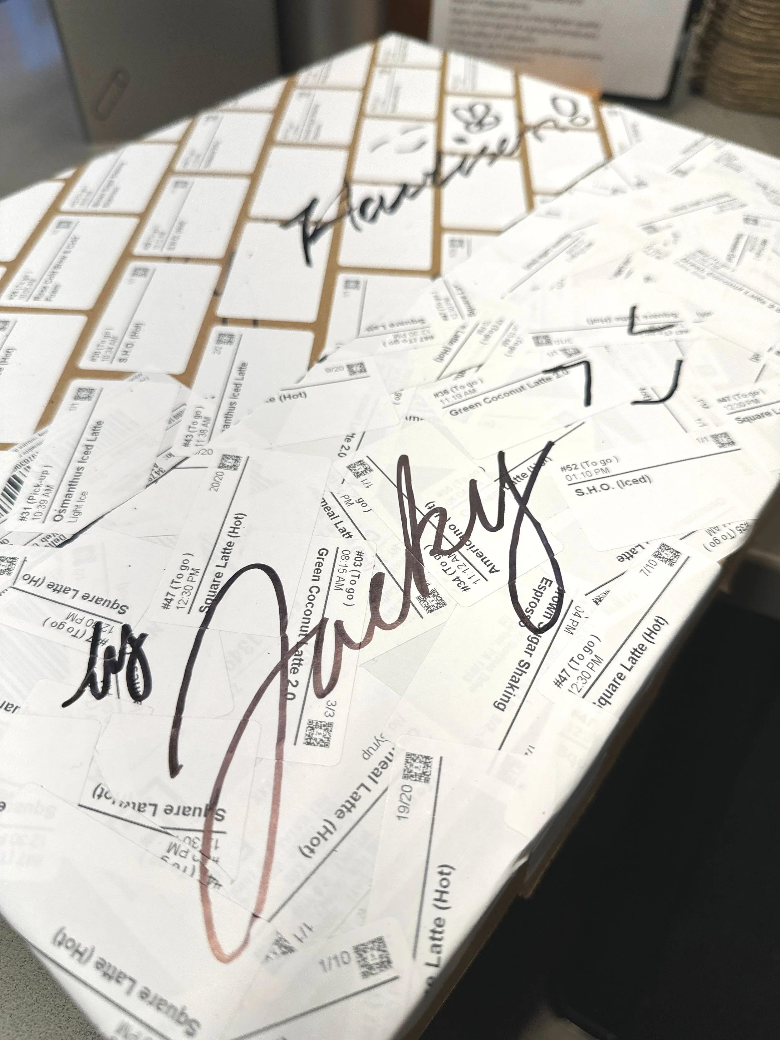 Order tickets and receipts covered in handwritten customer signatures at Square Coffee