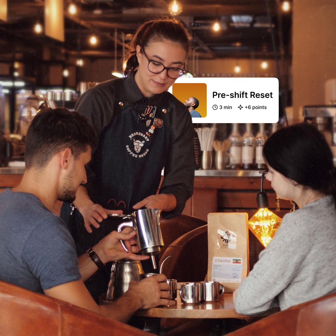 Barista serving customers at a coffee shop with a Pre-shift Reset app overlay
