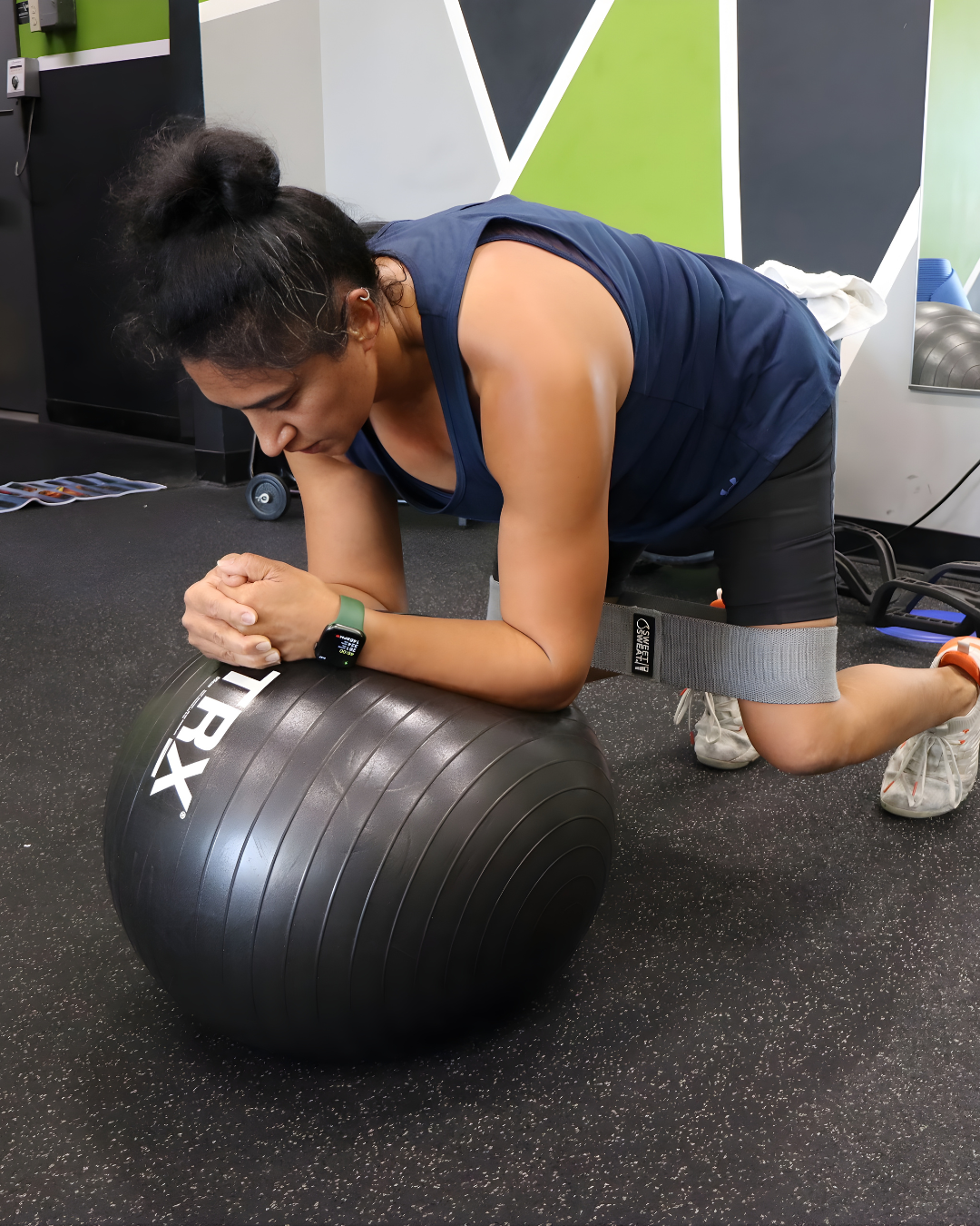 STR11VE member Preya doing a stability-ball plank with a resistance band