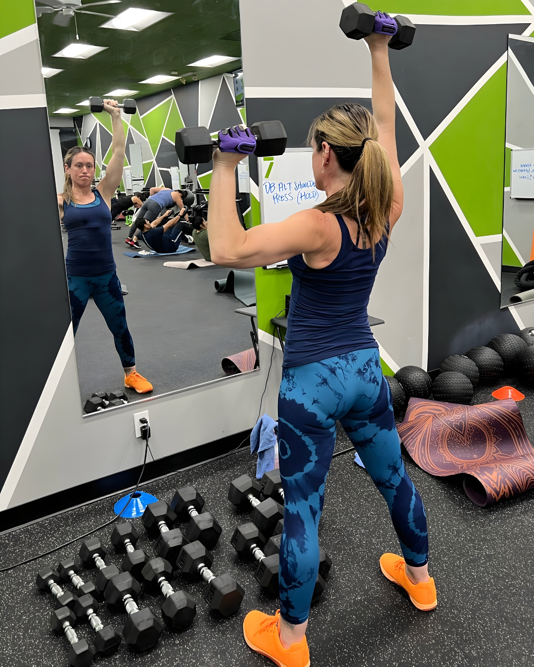 STR11VE member Brooke performing an overhead dumbbell shoulder press