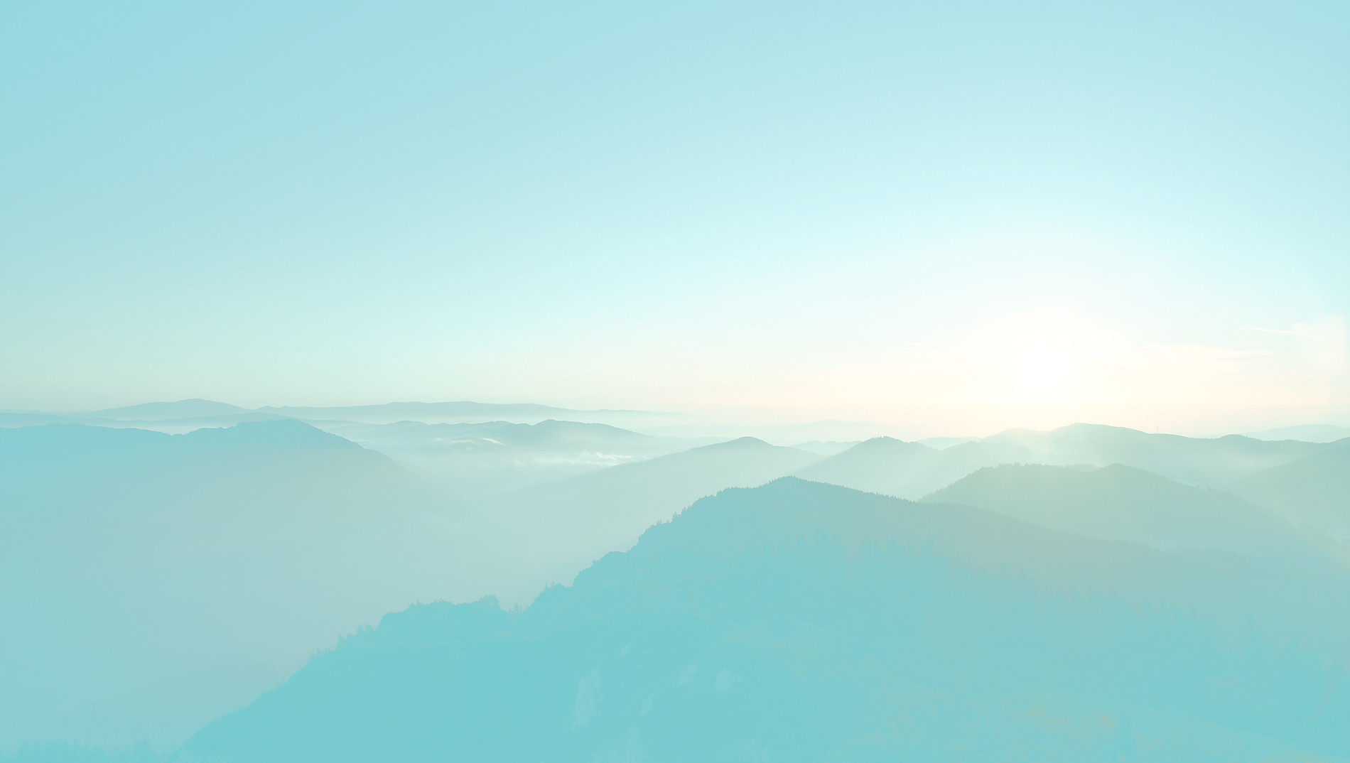 Misty mountain ranges at sunrise