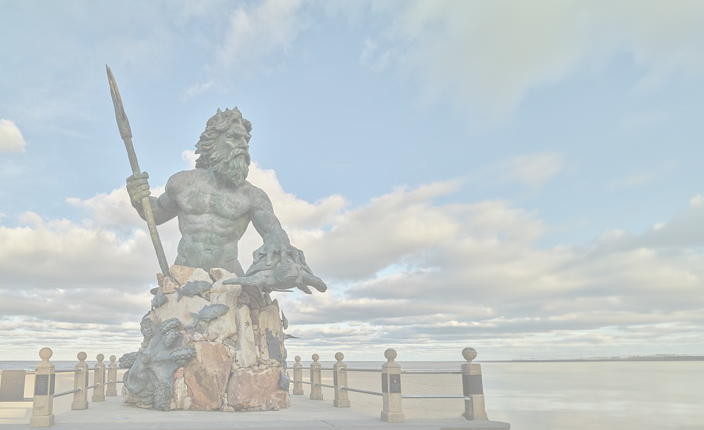 Bronze Poseidon statue holding a trident on the Norfolk waterfront boardwalk